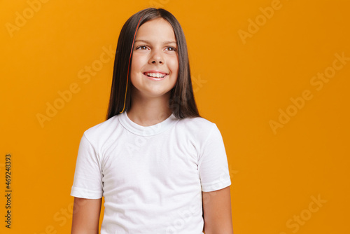White brunette girl wearing t-shirt smiling while looking aside