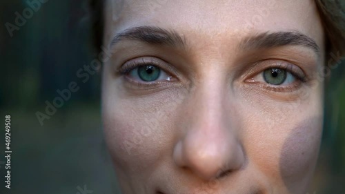 Close-up of a girl staring at the camera. Slow motion.