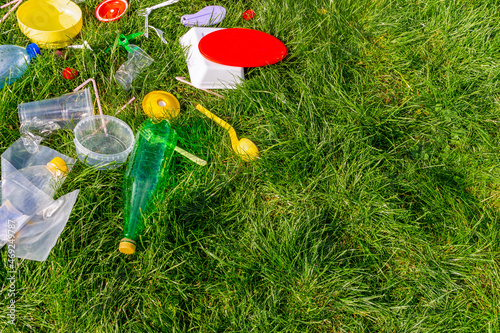 Reuse garbage, recycle, plastic free. Food plastic packaging, trash on green grass background. Recycling plastic. Environmental pollution, ecology concept