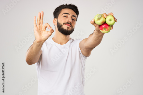 bearded man in white t-shirt apples holding healthy food