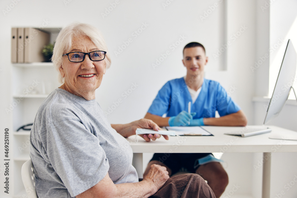 old woman at the doctor in the medical office old woman at the doctor in the medical office