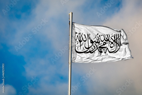 Obraz na płótnie A Flag of the Taliban in Afghanistan flying on a Flagpole against the Sky w salonie