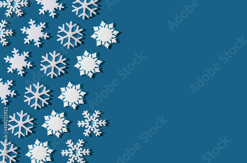Christmas background. Snowflake pattern. White snowflakes on blue. Snow. Winter mood. Conceptual abstraction. Styrofoam snowflake. New Year's pattern. Copy space.