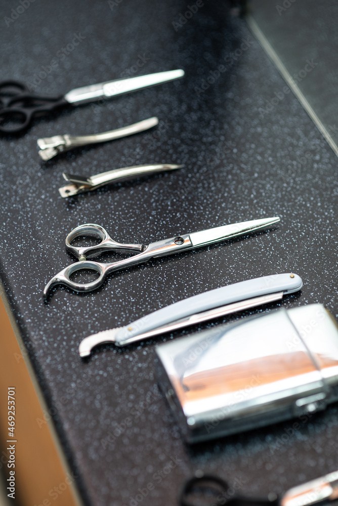 Set of professional instruments of men barber hair stylist on the table waiting to be used in work Set of professional instruments of men barber hair stylist on the table waiting to be used in work