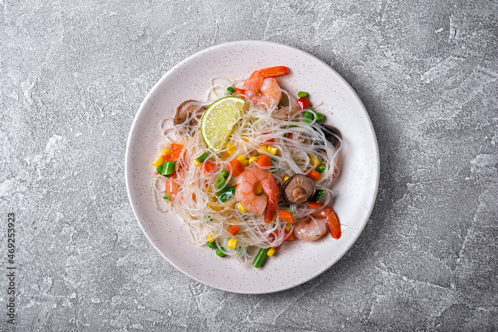 A traditional dish of Asian cuisine. Japanese noodles with shrimps, shiitake mushrooms and vegetables A traditional dish of Asian cuisine. Japanese noodles with shrimps, shiitake mushrooms and vegetables