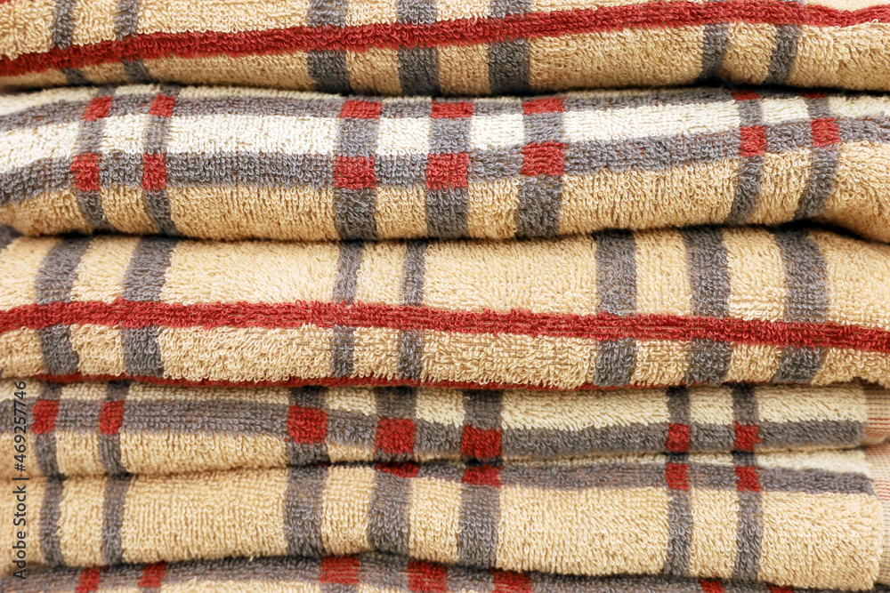 Stack of checkered terry towels. Soft background, bath textile with pattern close up Stack of checkered terry towels. Soft background, bath textile with pattern close up