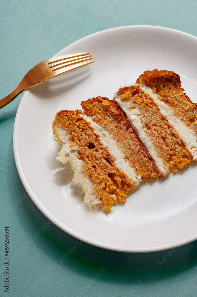 Plate with a piece of carrot cake on light green background pattern minimallistic bright shot Plate with a piece of carrot cake on light green background pattern minimallistic bright shot