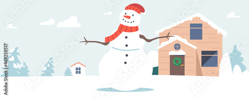 Funny Snowman Wear Knit Hat and Scarf Stand at Snowy Winter Time Landscape at Cottage Front Yard. Xmas Scene