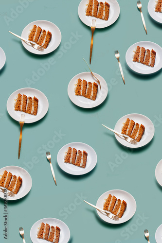 Plate with a piece of carrot cake on light green background pattern minimallistic bright shot