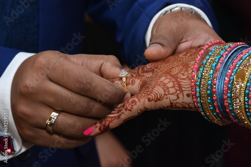 A newly married couple is celebrating their wedding ceremony by wearing gold and diamond rings. © Pranjal