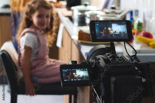 Fényképezés Video camera filming a movie scene with a young girl in the background