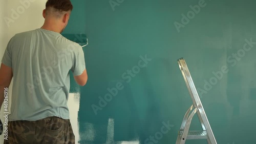 Woman gives husband a glass of water during renovation. Wife and husband family doing home improvements photo