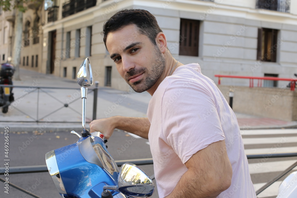 Handsome man riding a scooter Handsome man riding a scooter