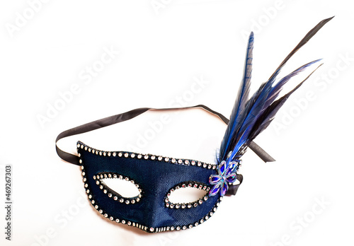 Carnival mask background. Blue female elegant carnival mask with feathers isolated on white. Venetian Face mask used for celebration Halloween, party, xmas, christmas, holiday, purim from masquerade © Sabrina Umansky