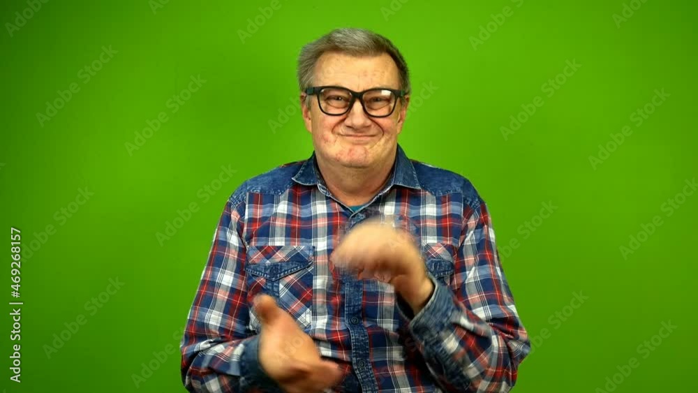 Mature adult strange man in stupid glasses is emotionally claps his hands. Mature adult strange man in stupid glasses is emotionally claps his hands.