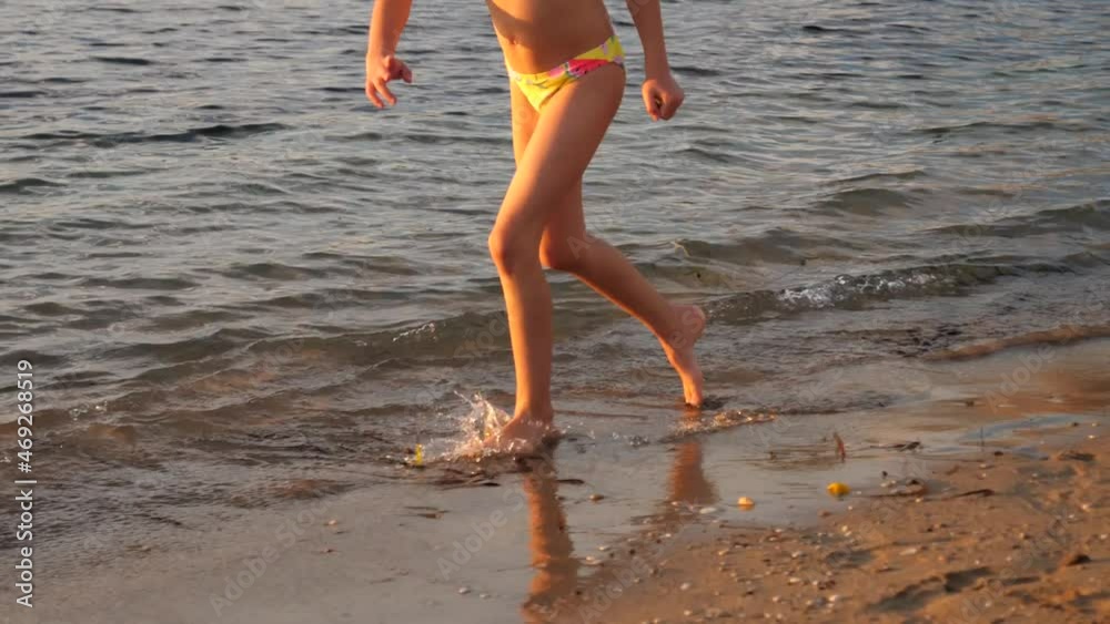Kid girl legs running on shallow waterline of Mediterranean sea in Paphos Cyprus Kid girl legs running on shallow waterline of Mediterranean sea in Paphos Cyprus