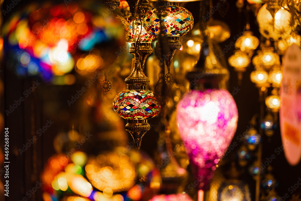 Assortment of lanterns mosaic lamps and oriental traditional lamps hanging in market Turkey.