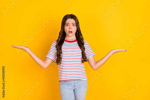 Photo of young girl amazed surprised show hands product offer advert promo solution pros cons isolated over yellow color background