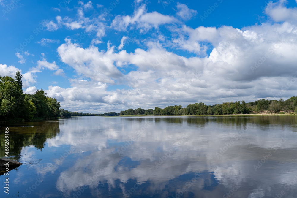Calm waters of the Loire reflect the bright blue sky, seen from the popular Loire à Vélo cycle path. Calm waters of the Loire reflect the bright blue sky, seen from the popular Loire à Vélo cycle path.