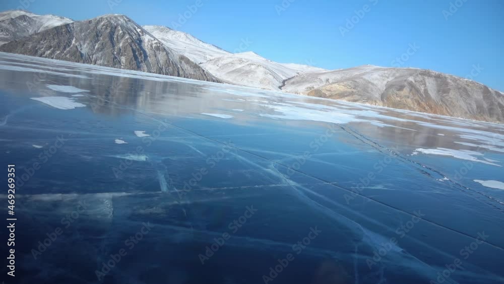 Gimbal vortex turn first-person window view of frozen lake Baikal, winter clear cracked ice, scenic reflection of mountains. Travel by transport car hovercraft in Siberia Russia expedition. Sunny day Gimbal vortex turn first-person window view of frozen lake Baikal, winter clear cracked ice, scenic reflection of mountains. Travel by transport car hovercraft in Siberia Russia expedition. Sunny day