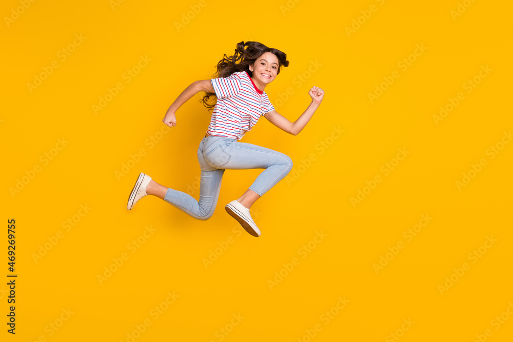 Full body profile side photo of young excited girl happy smile jump up run hurry sale isolated over yellow color background