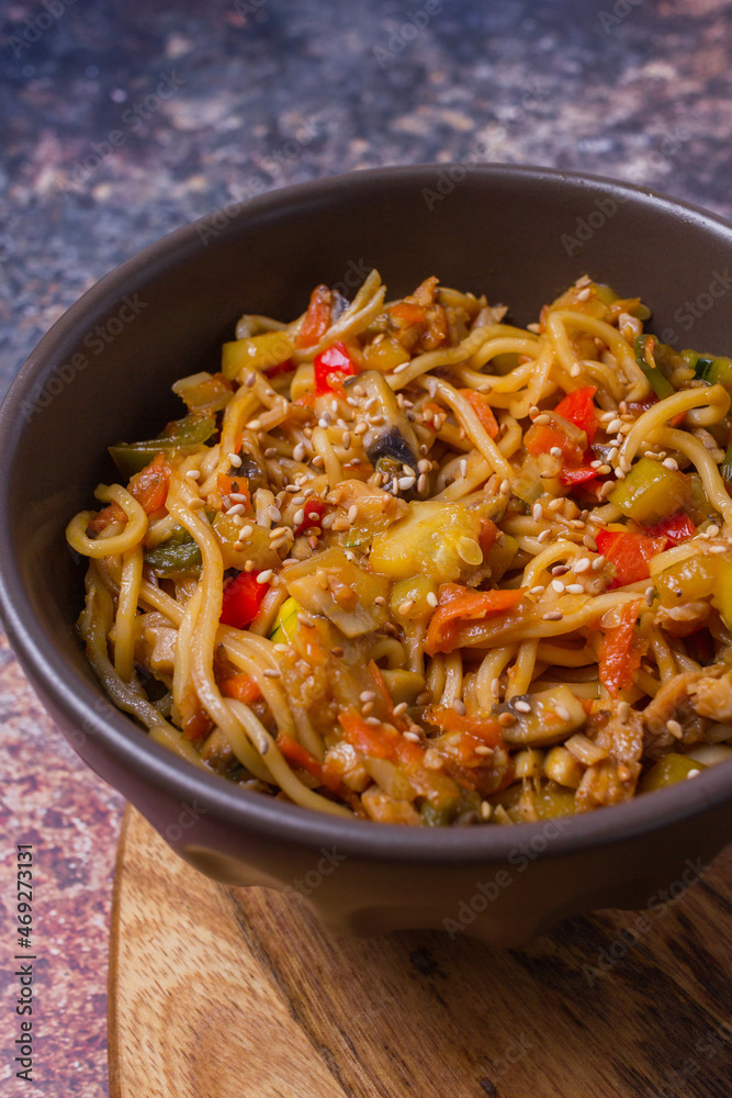 Stir fry noodles with vegetables on dark bowl. Stir fry noodles with vegetables on dark bowl.