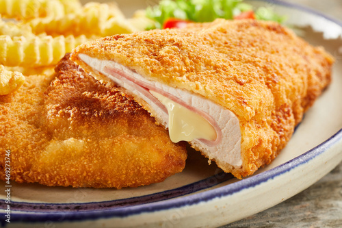 Tableau sur toile Tasty cordon bleu with cheese on plate