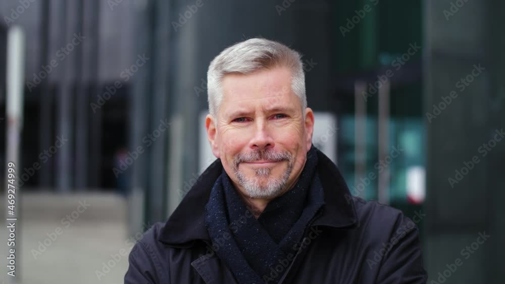 Portrait of middle aged man changing expression from angry to happy in city. Handsome senior citizen downtown looking at camera first frowning then smiling. Changing opinion concept. Portrait of middle aged man changing expression from angry to happy in city. Handsome senior citizen downtown looking at camera first frowning then smiling. Changing opinion concept.