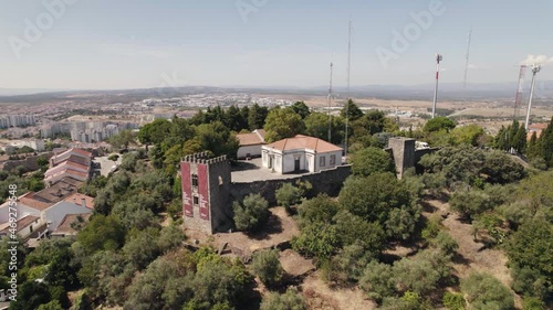 Aerial orbiting over old Castle fortress on hilltop surrounded by Vegetation - Castelo Branco photo