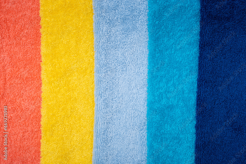 Fototapeta premium Composition of colored cotton towels. The concept of softness and purity