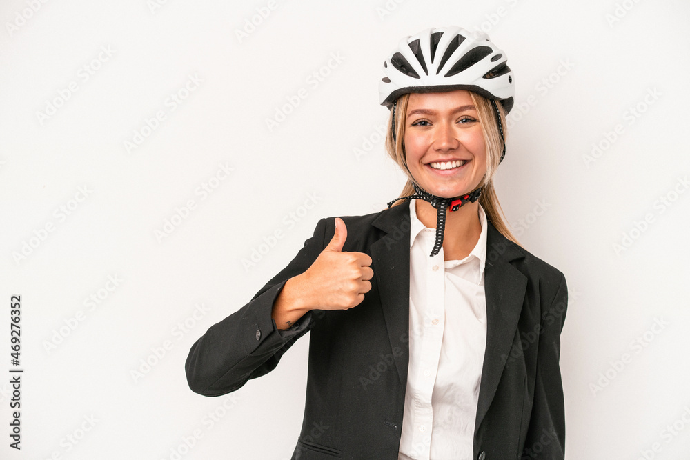 Young caucasian business woman wearing a bike helmet isolated on white background smiling and raising thumb up Young caucasian business woman wearing a bike helmet isolated on white background smiling and raising thumb up