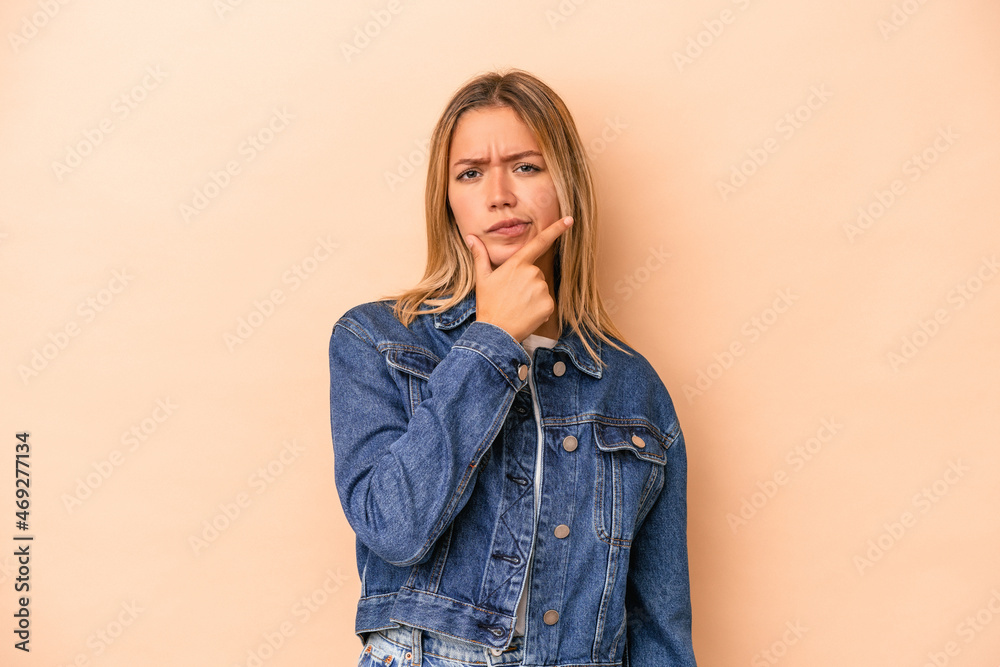 Young caucasian woman isolated on beige background contemplating, planning a strategy, thinking about the way of a business. Young caucasian woman isolated on beige background contemplating, planning a strategy, thinking about the way of a business.