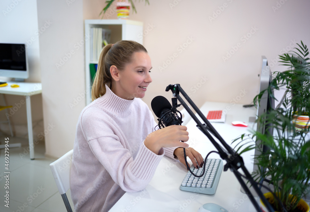 young woman is streaming while sitting in coworking at the computer young woman is streaming while sitting in coworking at the computer