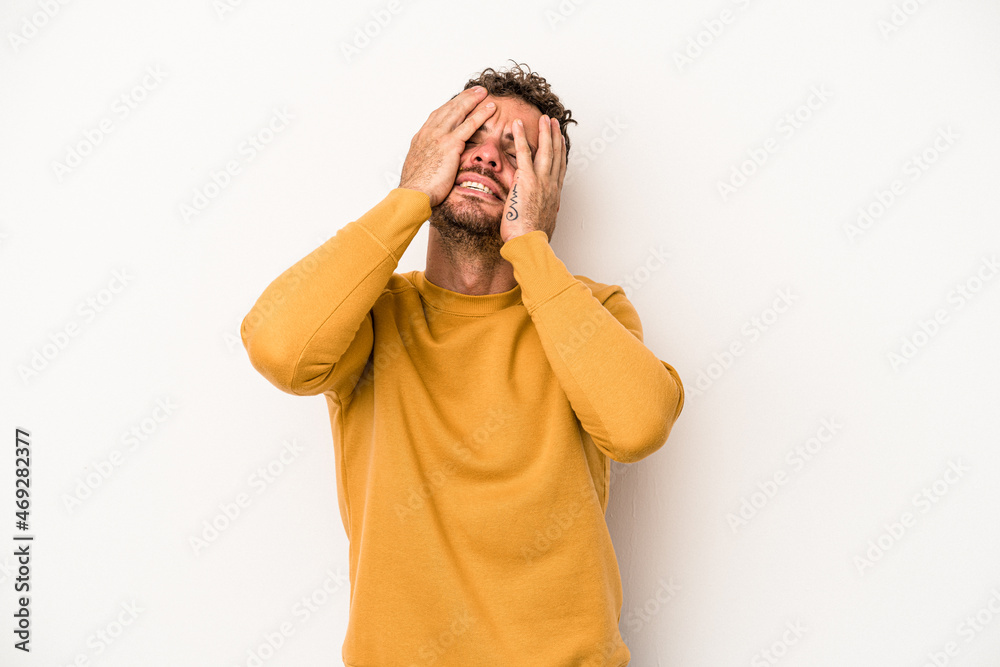 Young caucasian man isolated on white background laughs joyfully keeping hands on head. Happiness concept. Young caucasian man isolated on white background laughs joyfully keeping hands on head. Happiness concept.