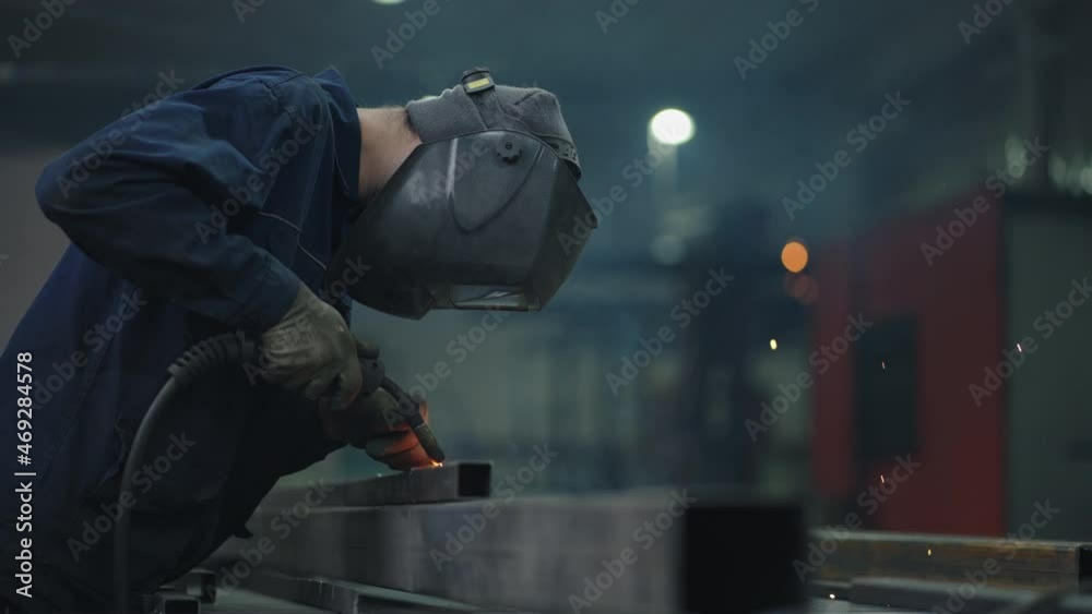 Welder carries out welding of metal. welder in special mask connects metal parts at bright sparks. welder in special mask connects metal parts at bright sparks slow motion Welder carries out welding of metal. welder in special mask connects metal parts at bright sparks. welder in special mask connects metal parts at bright sparks slow motion