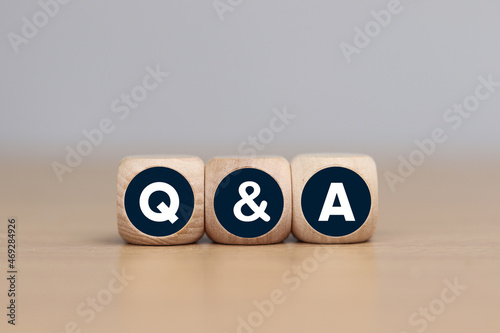 Wooden cube with questions and answers text. Business concept