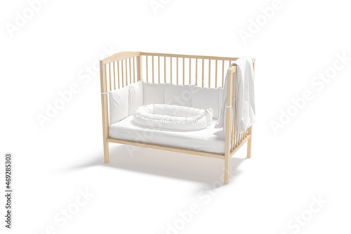 Blank wood cot with white crib sheet and nest mockup photo