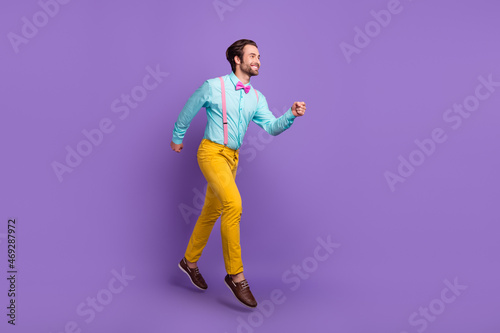 Full size profile photo of fast millennial cool guy run wear tie suspenders shirt trousers shoes isolated on purple background © deagreez