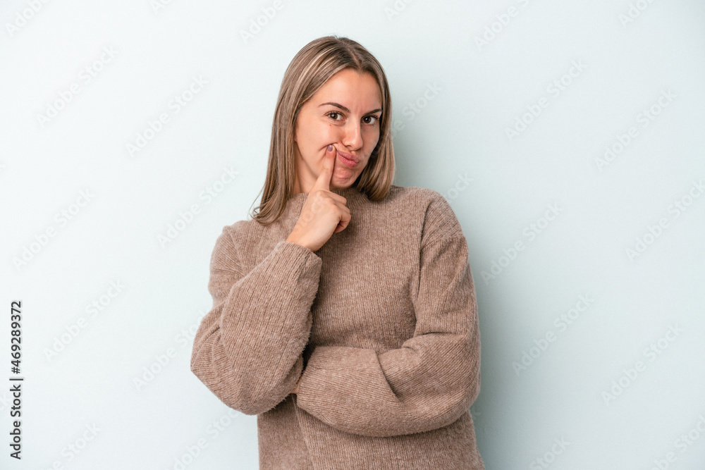 Young caucasian woman isolated on blue background unhappy looking in camera with sarcastic expression. Young caucasian woman isolated on blue background unhappy looking in camera with sarcastic expression.