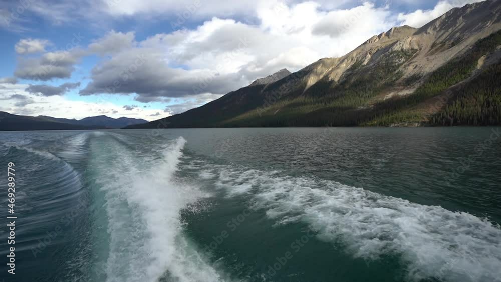 Coast and Motor Boat Wake on Surface of Lake Maligne, Jasper National Park, Alberta, Canada, Tilt Down, Full Frame Coast and Motor Boat Wake on Surface of Lake Maligne, Jasper National Park, Alberta, Canada, Tilt Down, Full Frame