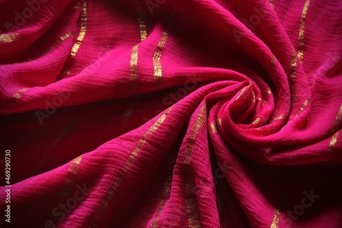 Lightweight pink coloured cloth swirl background