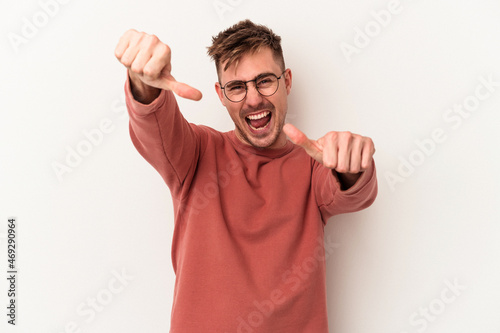 Young caucasian man isolated on white background raising both thumbs up, smiling and confident.