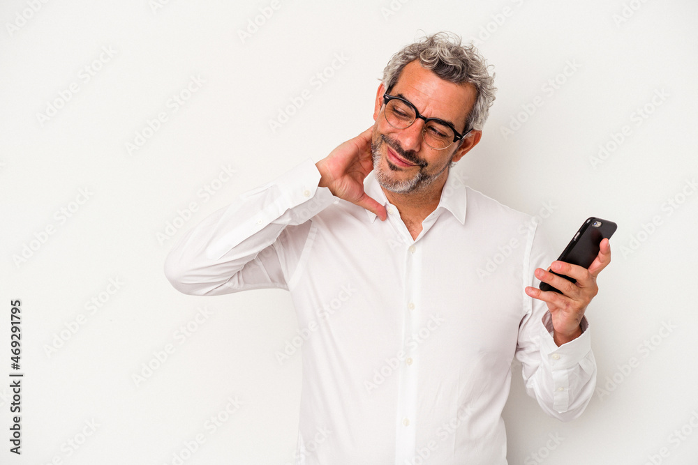 Middle age caucasian business man holding a mobile phone isolated on white background touching back of head, thinking and making a choice. Middle age caucasian business man holding a mobile phone isolated on white background touching back of head, thinking and making a choice.
