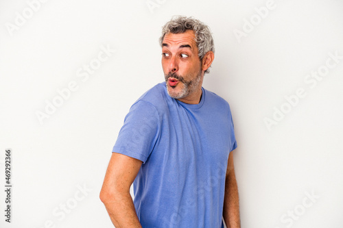 Middle age caucasian man isolated on white background looks aside smiling, cheerful and pleasant.