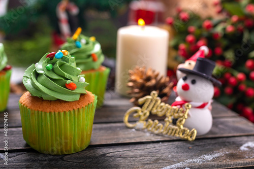 Christmas cupcakes with snowman and santa clause made from sugar on wooden table for celebrate in christmas and new year festival.