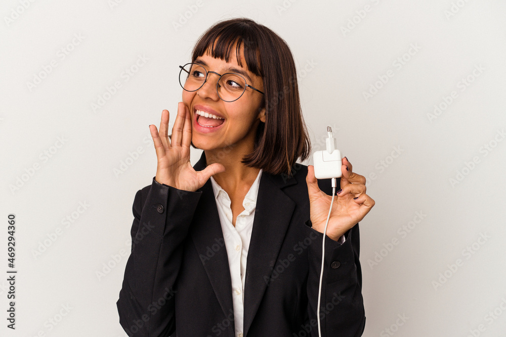 Young mixed race business woman holding a phone charger isolated on white background standing with outstretched hand showing stop sign, preventing you. Young mixed race business woman holding a phone charger isolated on white background standing with outstretched hand showing stop sign, preventing you.