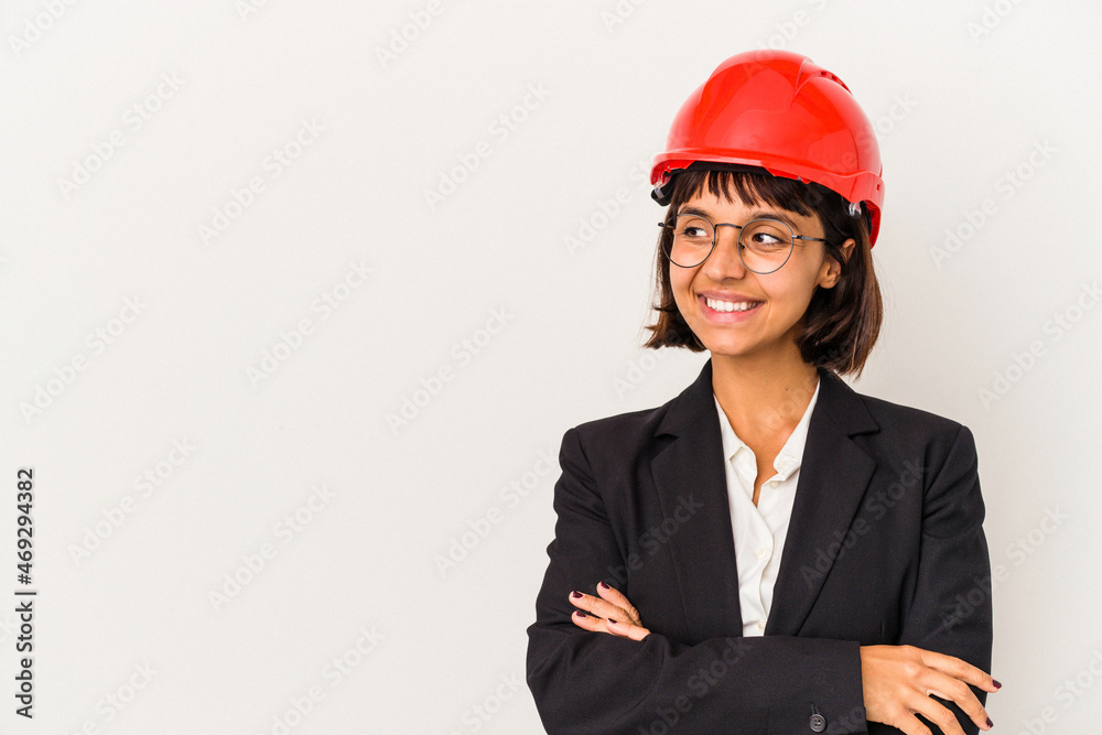 Young architect woman with red helmet isolated on white background smiling confident with crossed arms. Young architect woman with red helmet isolated on white background smiling confident with crossed arms.