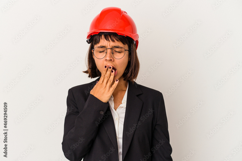 Young architect woman with red helmet isolated on white background yawning showing a tired gesture covering mouth with hand.