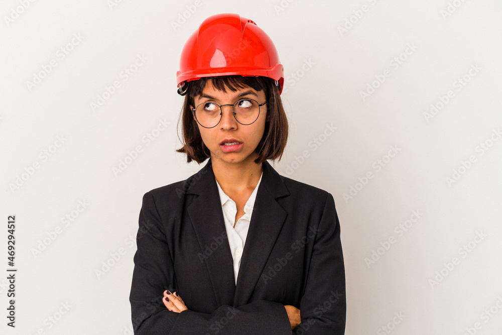 Young architect woman with red helmet isolated on white background tired of a repetitive task. Young architect woman with red helmet isolated on white background tired of a repetitive task.
