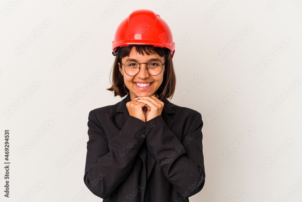 Young architect woman with red helmet isolated on white background smiling happy and confident, touching chin with hand. Young architect woman with red helmet isolated on white background smiling happy and confident, touching chin with hand.